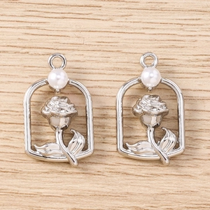 Detail of silver rose flower pendants with white pearls for DIY jewelry making