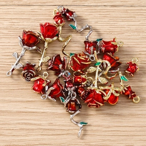 Detailed view of red enamel rose flower pendants for DIY jewelry making accessories