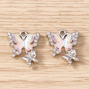 Detail of silver butterfly pendants with white rhinestones and iridescent opal effect