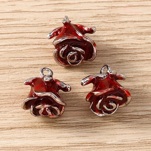 Detail of red enamel rose flower charms with silver metal rings for DIY jewelry making