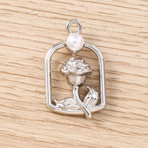 Detail shot of silver rose flower frame pendant with white pearl and hanging loop