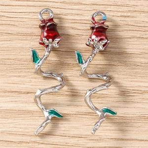 Close-up of elegant red rose flower pendants with green leaves and silver spiral stems