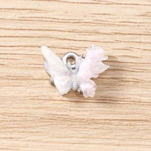 Macro view of gradient rhinestone butterfly pendant with silver metal ring connector