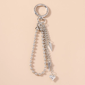 Detail view of punk silver metal heart keychain with spiked pendants and beaded chains