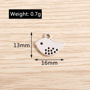 Detail showing vintage silver bird charm dimensions of 13mm by 16mm and 0.7g weight