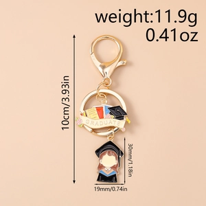 Detailed size view of golden graduate keychain with a blue academic girl figure pendant