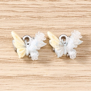 Macro view of gradient rhinestone butterfly charms with glitter for DIY jewelry making