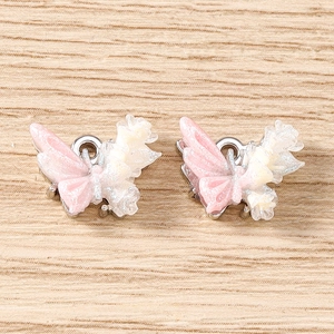 Close-up of gradient resin butterfly pendants with silver rings for DIY jewelry