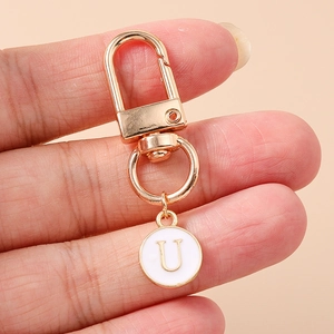 Minimalist gold alphabet keyring with white enamel letter U pendant and lobster clasp