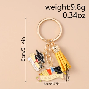 Detail showing doctoral cap tassel keychain with graduation scroll and colorful books charms