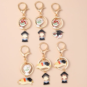 Set of 6 graduation keychains with gold metal trim, enamel bouquet, and graduate motifs
