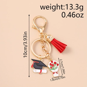 Detail view of graduation keychain with red tassel, graduation cap, and dimension markings