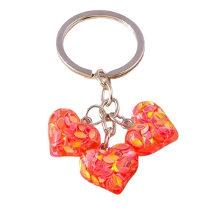 Porte-clés cœur avec trois pendentifs en résine rouge et paillettes irisées pour sac