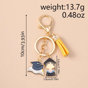 Macro view of a graduation keychain with a yellow tassel and enamel charms detailing the size