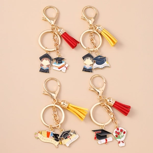 Set of four graduate themed keychains with colorful tassels and gold metal charms