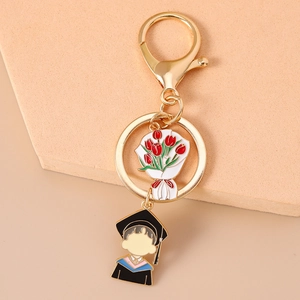 Detail of graduation keychain with metal tulip bouquet and student charm in enamel