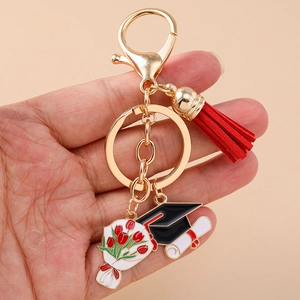Close-up of graduation keychain with red tassel, mortarboard, and tulip charms