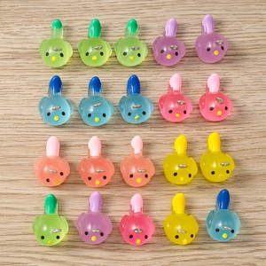 Macro shot of colorful resin bird charms with metal hooks for DIY jewelry making accessories