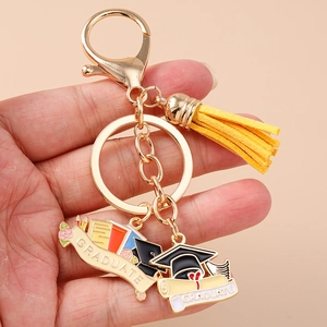 Macro view of graduation keychain with golden metal ring and yellow suede tassel