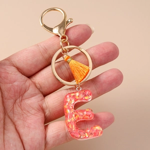 Letter E resin keychain with colorful sequins, orange tassel and golden lobster clasp