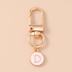 Detail of a pink and gold letter D charm pendant with a durable metal lobster clasp