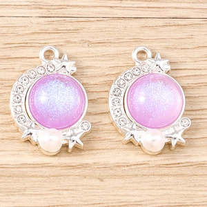 Detail of moon and star pendant with purple opal stone and rhinestone accents