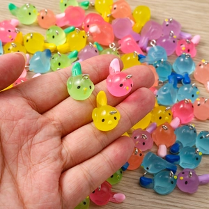 Macro shot of colorful resin bird charms with silver metal rings for DIY jewelry making