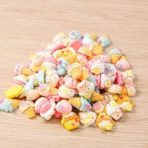Macro shot of colorful resin dessert charms including ice cream and cupcakes for DIY projects