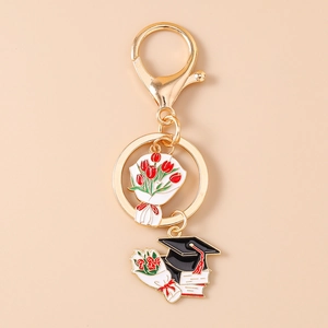 Detail of graduation keychain with gold metal lobster clasp, tulip bouquet and black mortarboard