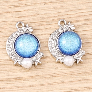 Celestial crescent moon charm with blue opal-like glitter and white faux pearls