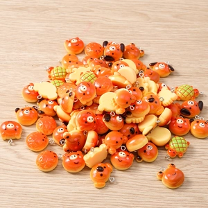 Close-up of assorted resin animal bread charms with metal rings for DIY jewelry making