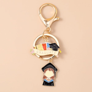 Macro detail of enamel graduation keychain with a student charm and graduate emblem