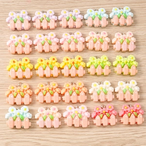 Macro detail of mixed resin flower pendants with metal rings for DIY jewelry making