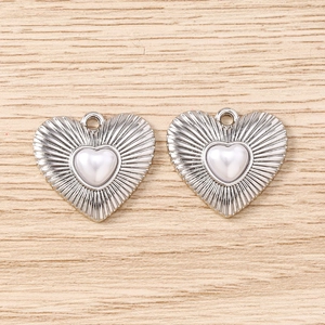 Dettaglio di ciondoli a cuore argento con trama radiale e perla bianca per creare gioielli