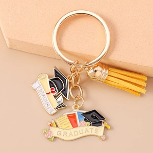 Macro detail of graduation keychain with yellow tassel and colorful graduate enamel charms