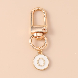 Detail of gold letter O initial pendant with lobster clasp for bags and keychains