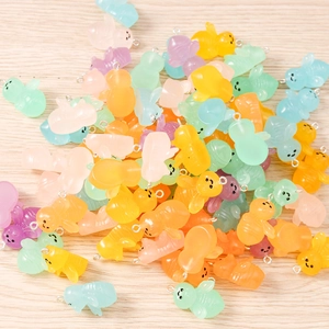 Macro shot of colorful resin bee charms with metal loops in assorted macaron shades