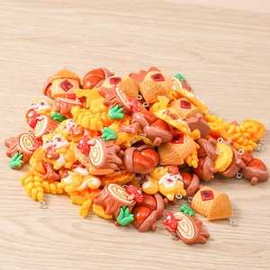 Detailed macro view of resin squirrel and acorn charms for DIY jewelry making