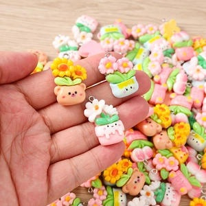 Close-up of pastel resin flower and animal charms with metal loops for DIY jewelry