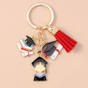 Detailed view of graduation keychain with enamel cartoon student charm and red tassel pendant