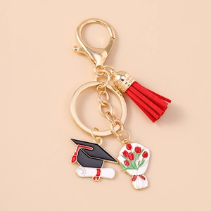 Detailed view of graduation keychain with red tassel, mortarboard and tulip charms