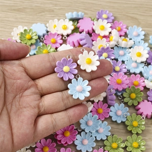 Detailed macro shot of colorful daisy resin charms for DIY jewelry making