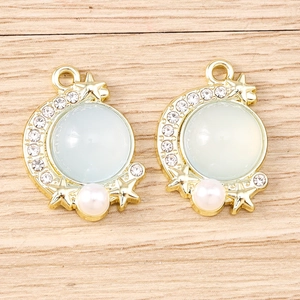 Detail showing moon and star charms with opal stones, pearls, and rhinestones for DIY jewelry