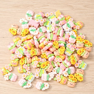 Flat lay of colorful resin flower and cartoon charms for DIY jewelry making and crafts