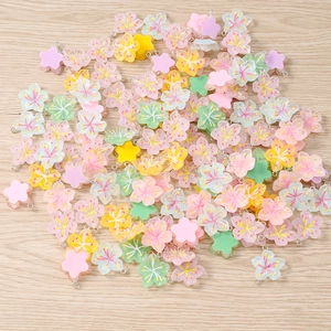 Detailed view of colorful resin cherry blossom flower pendants for DIY jewelry crafting