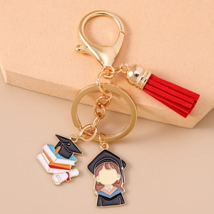 Detailed view of graduation keychain with red tassel and cartoon graduate charm