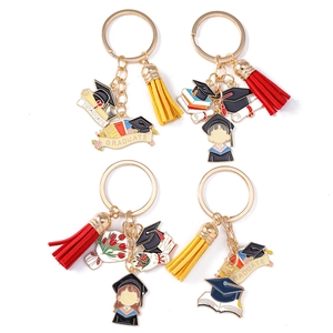 Set of four graduation keychains with tassels and cartoon student enamel charms