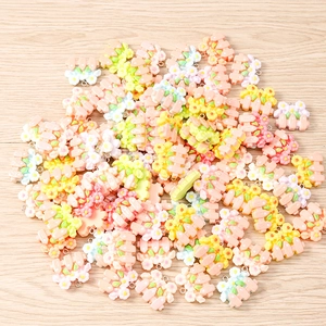 Detailed macro view of resin flower fence charms with metal loops for DIY jewelry making