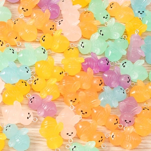 Close-up of colorful resin bee charms for DIY jewelry making with metal rings