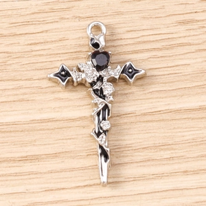 Detailed view of Gothic silver cross pendant with black heart gemstone and rose vines